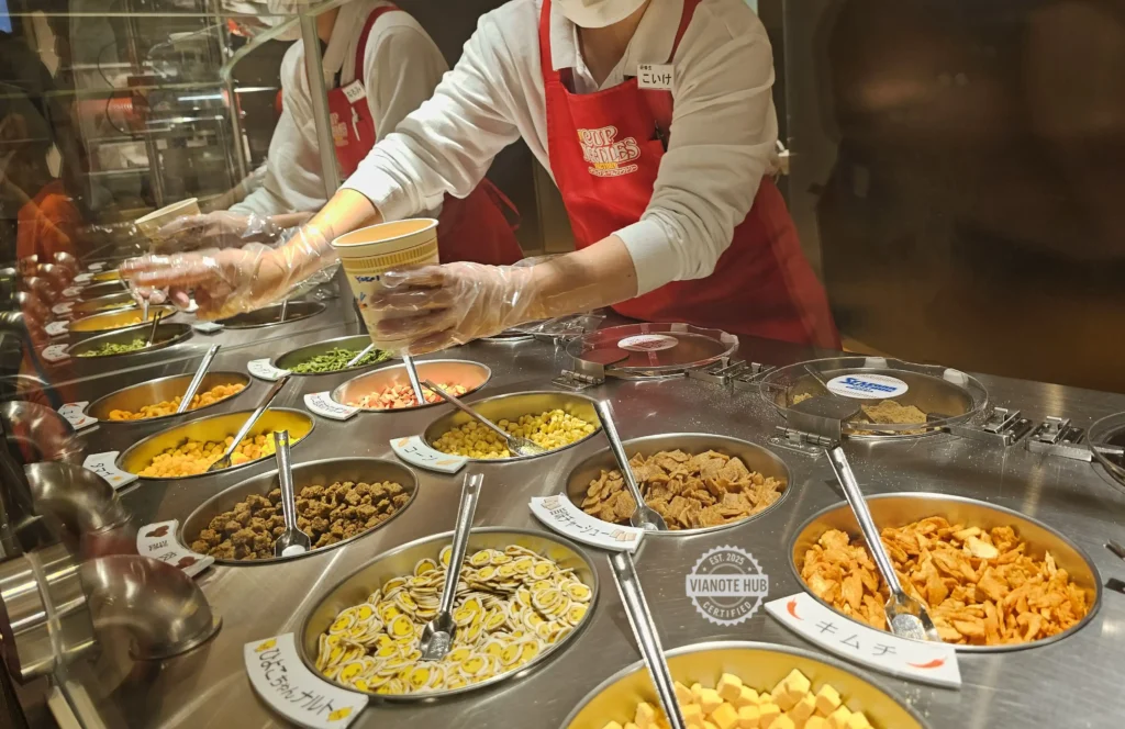 They add your choice of toppings for you.